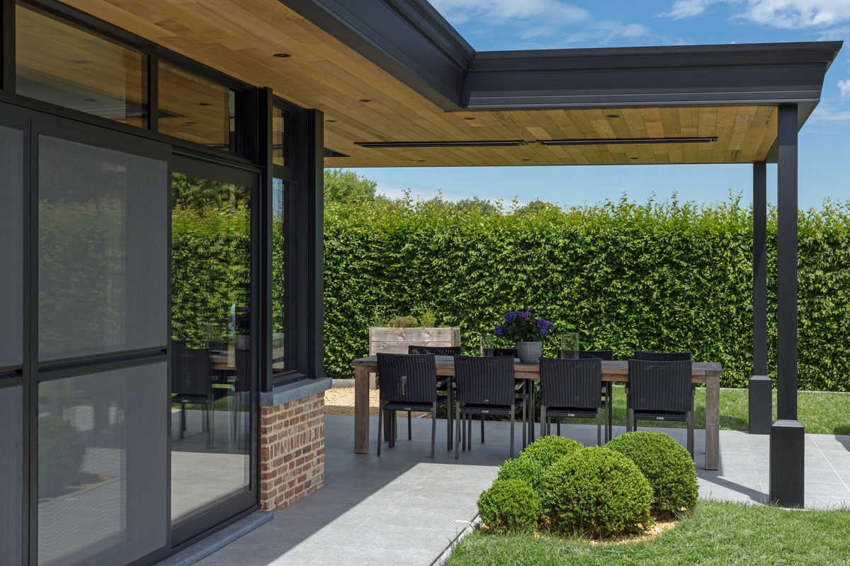 Outdoor patio in Indio, CA, showcasing a dining table with chairs, sheltered by a patio cover.