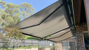 A patio features a newly installed awning, enhancing outdoor comfort and protection from the elements.